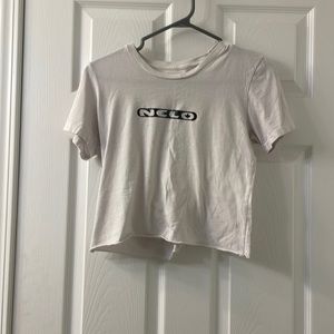 White shirt reads “neco” on the front with a design in the back